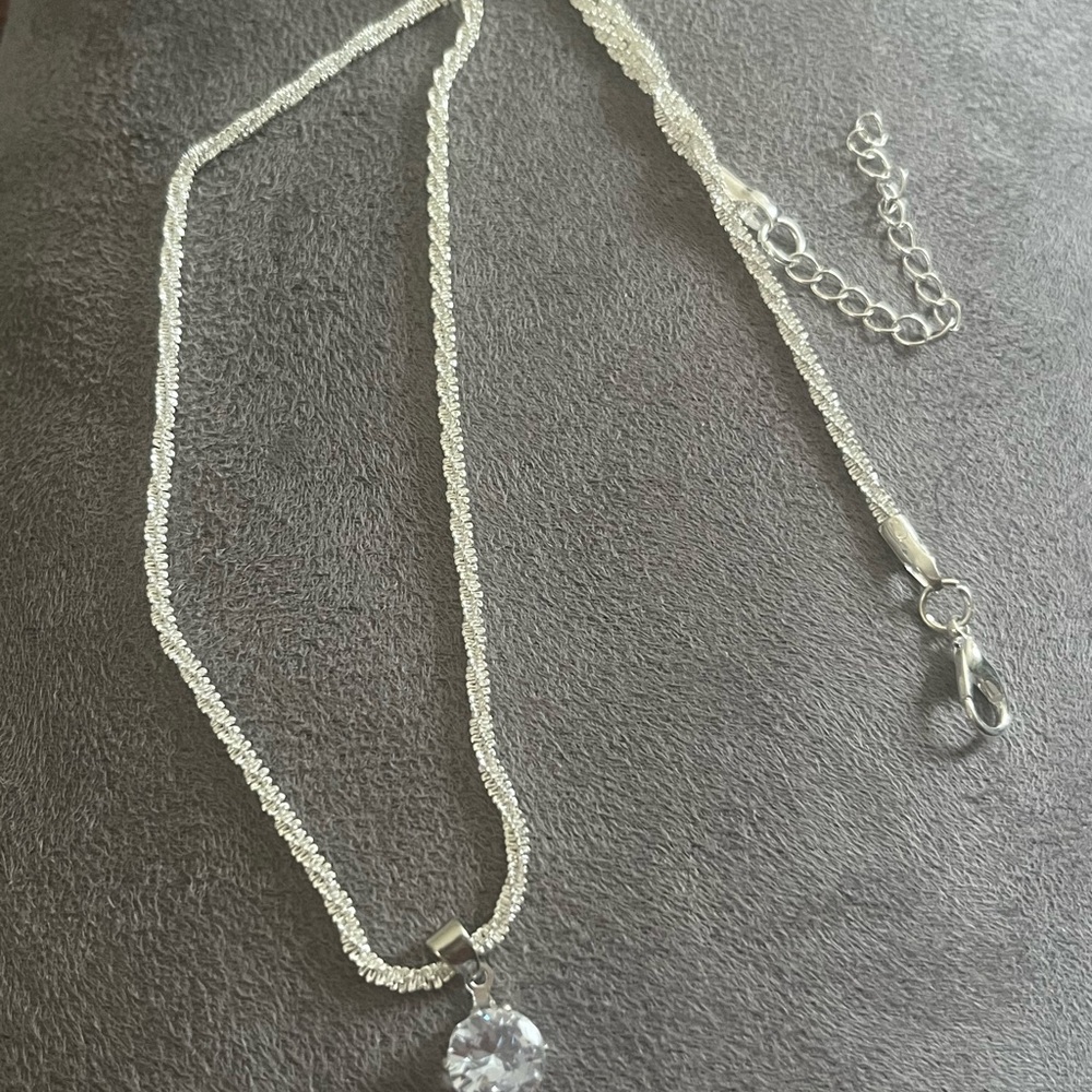 GRA certified Moissanaite pendant with silver chain.